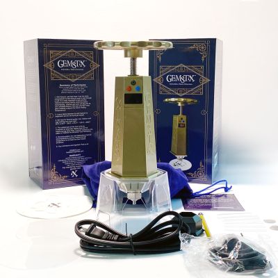 The lightweight GEMSTX portable rosin press standing next to its retail packaging, highlighting its travel-friendly size.